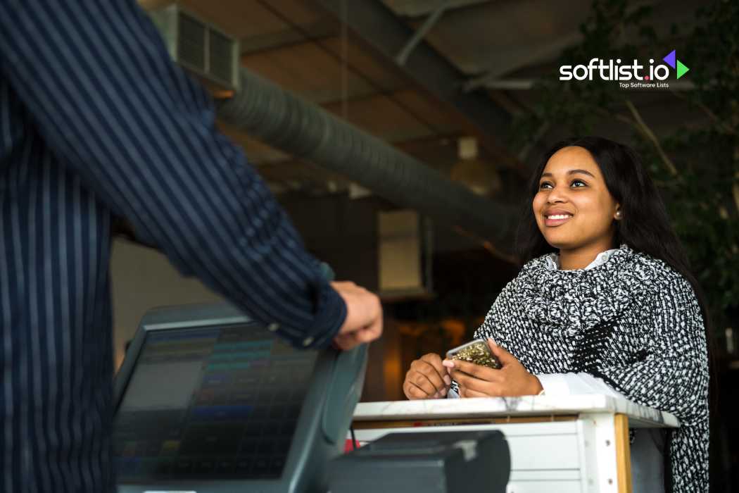 Smiling woman at checkout counter, ready to pay