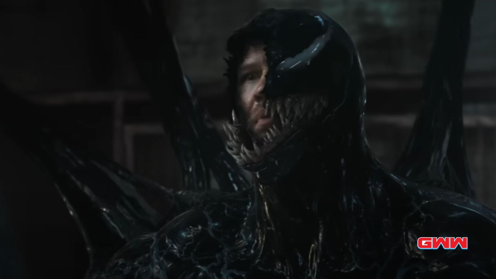 Half-transformed Eddie with sharp teeth and black, Venom-like suit.