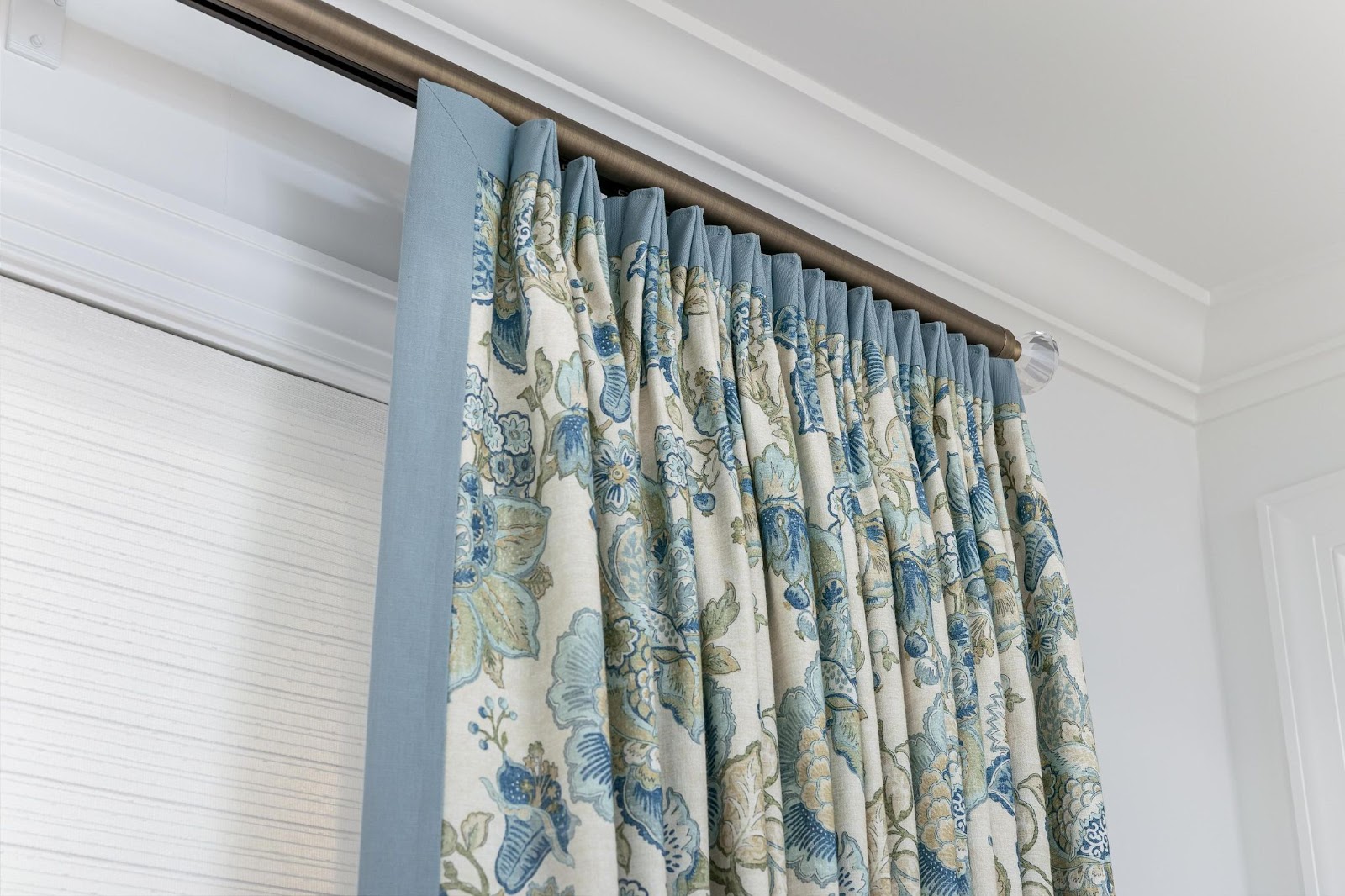 Custom blue patterned mortorized drapes in the living room of a Chattanooga home