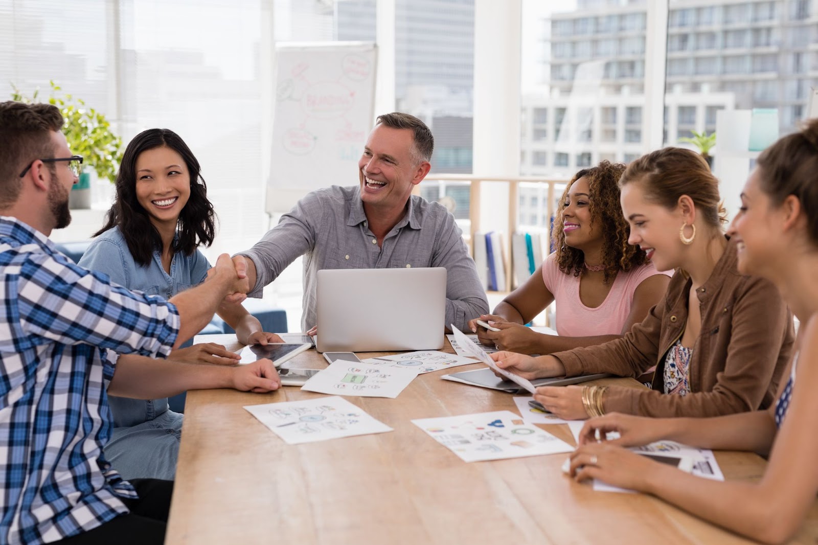 Executives are shaking hands with employees.