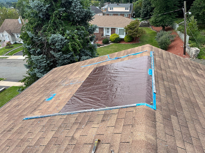 A roof with damaged shingles prepared for repair by our expert roofers at Boundless Roofing & Chimney.