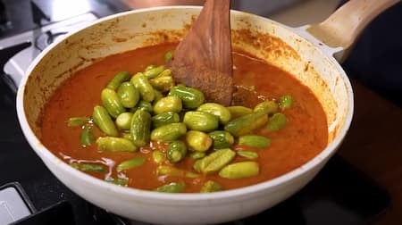 Masala being mixed with tendli in the pan, garnished with kasoori methi and coriander.