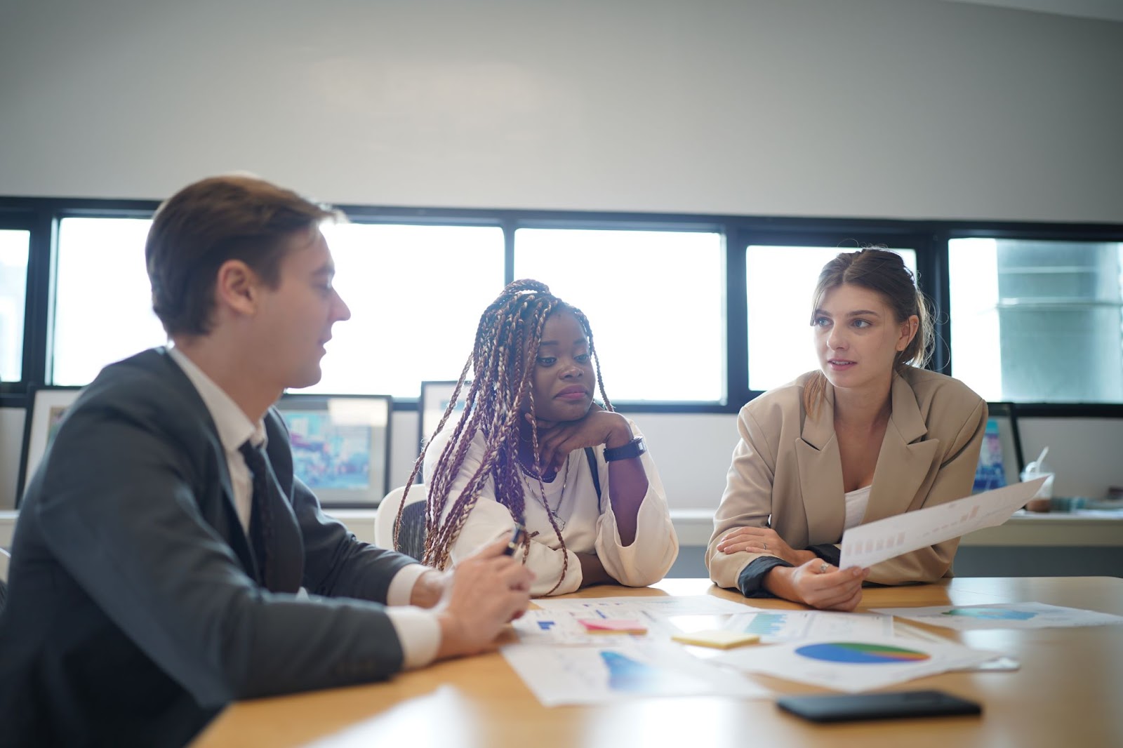 A group of business professionals discussing risk management during a meeting