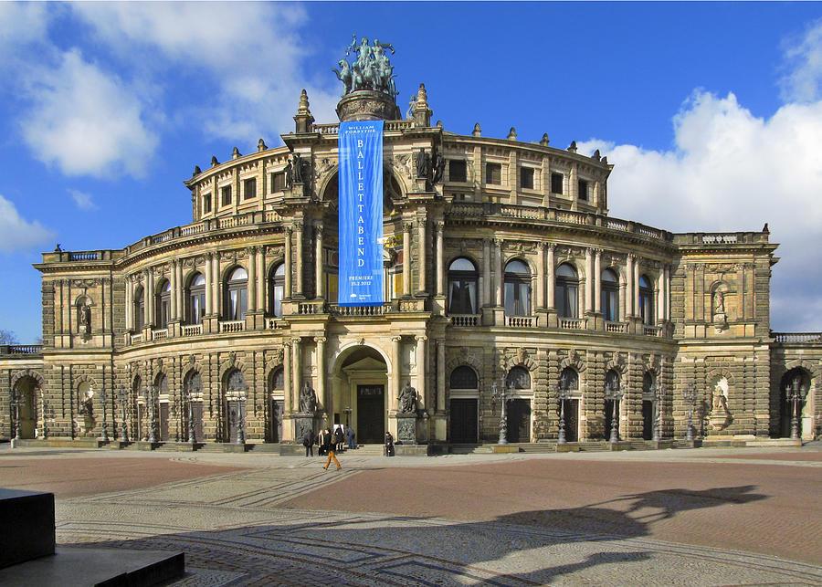 A large building with a blue banner with Semperoper in the background

Description automatically generated