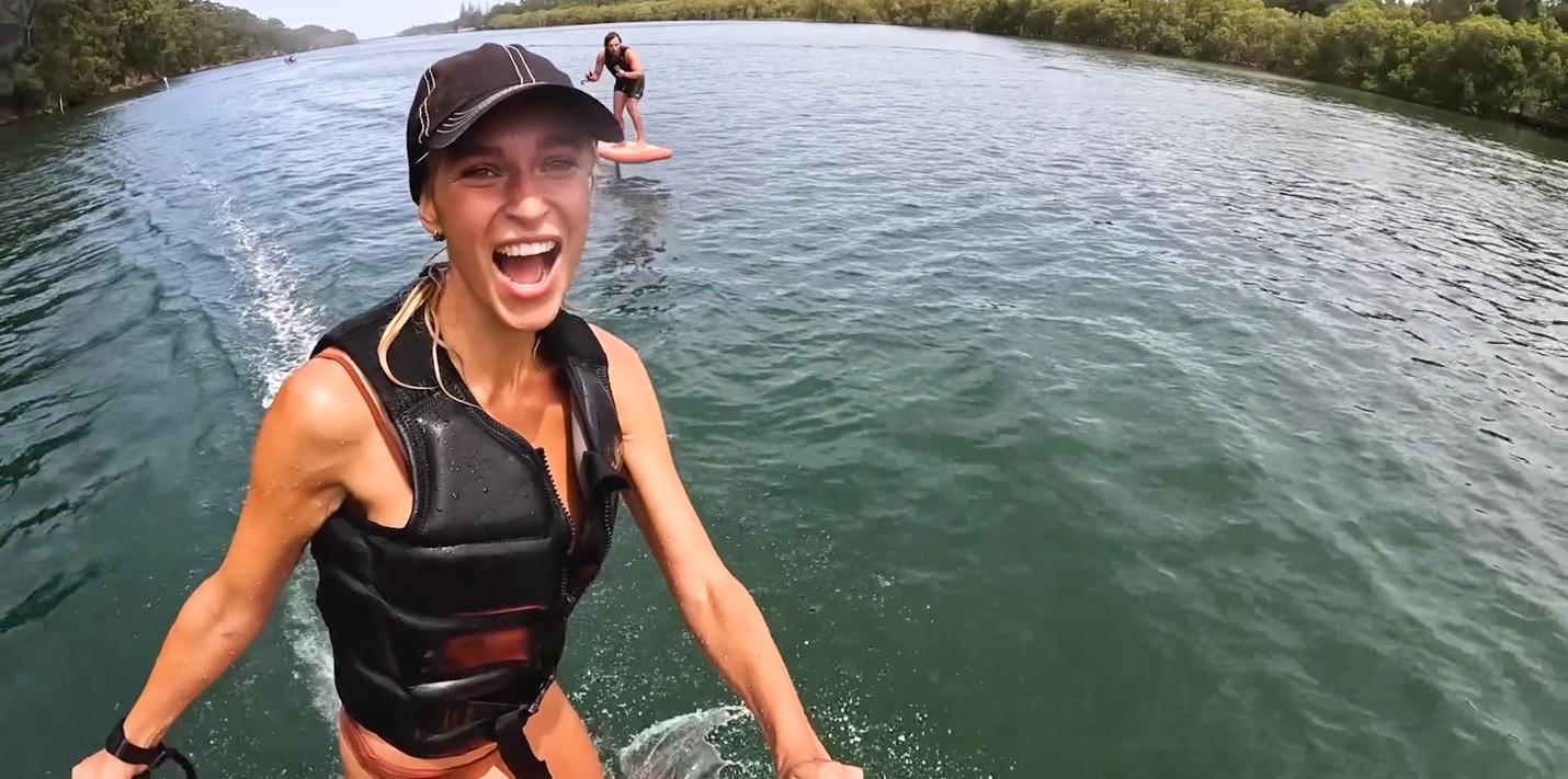 A person in a life jacket on a body of water

Description automatically generated