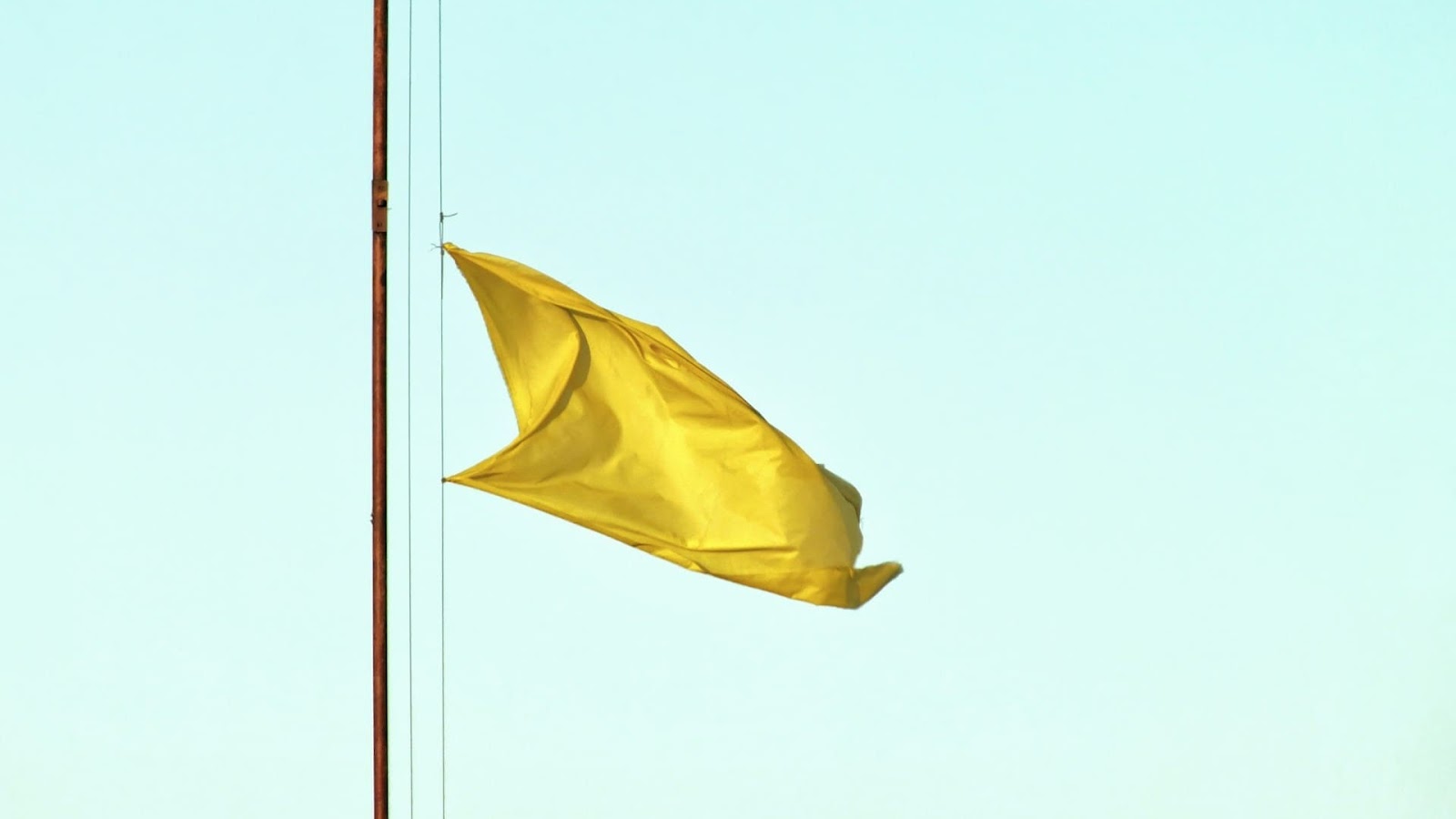 An image of a yellow safety flag at the beach
