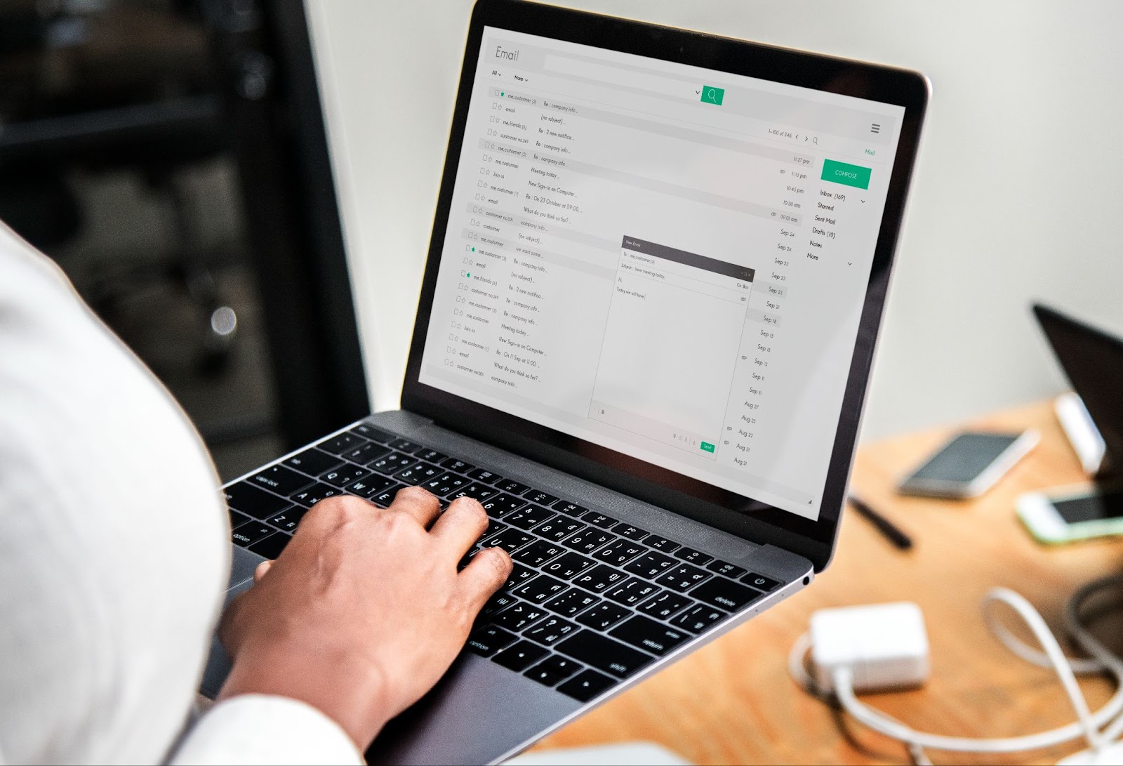 person writing an email on a laptop