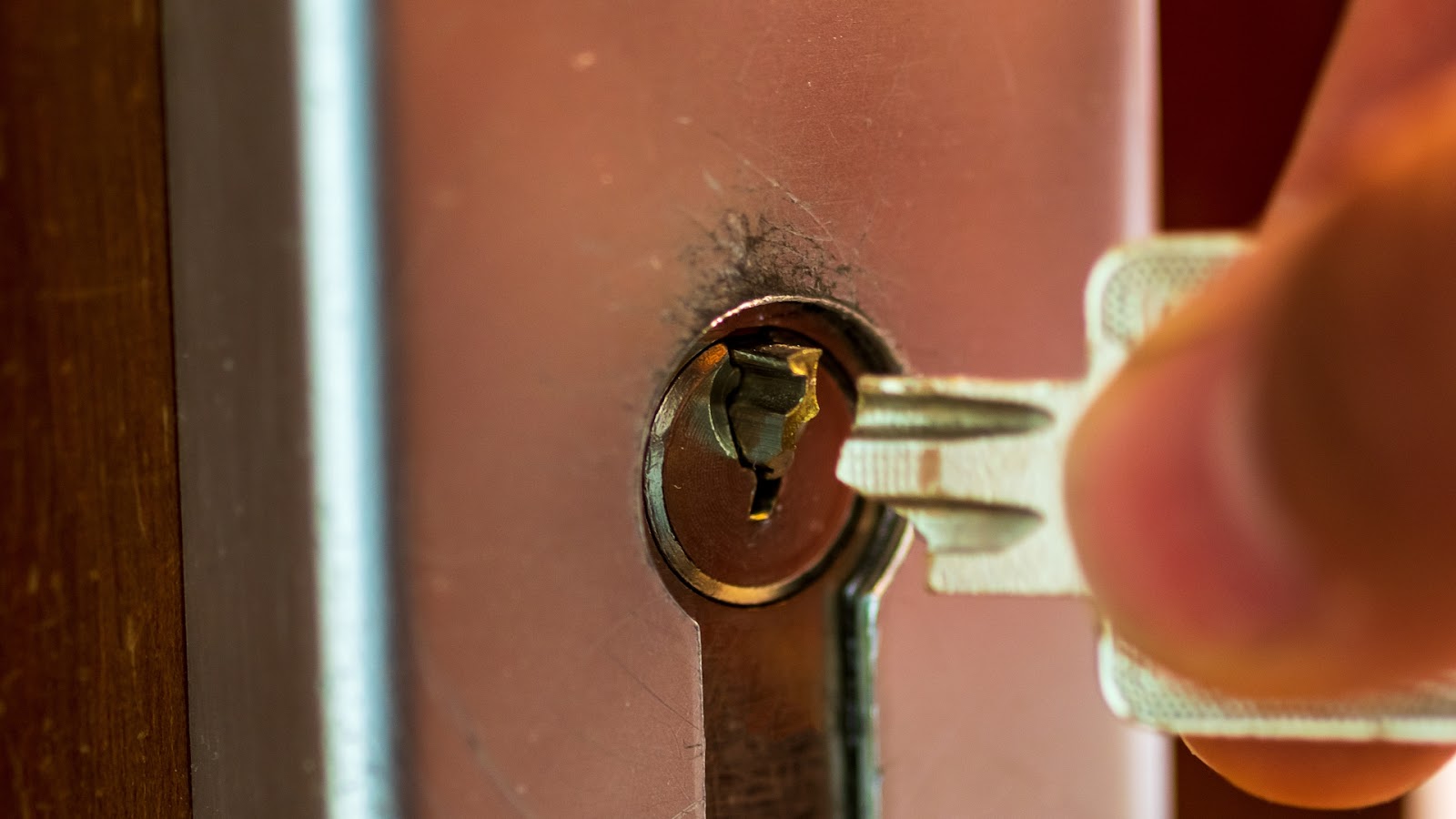 A broken key stuck in a door lock, causing an office lockout.