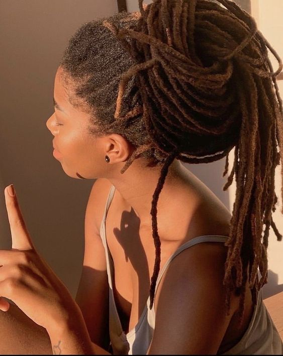 Picture of a lady wrapping her hair in a bun