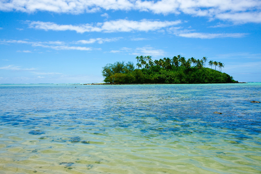 Blue water with a picturesque island located in the center