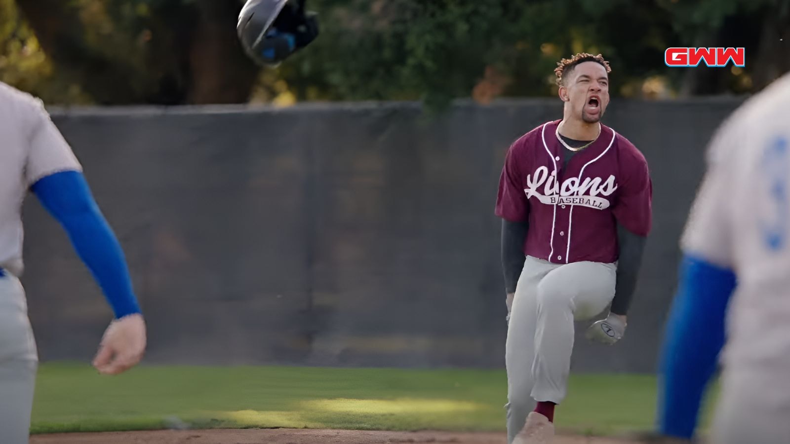 Damon in maroon Lions uniform celebrating after scoring, helmet flying off.