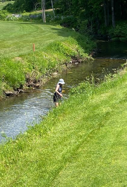 A person standing in a stream

Description automatically generated