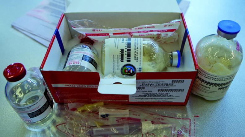 A box with a bottle and syringe

Description automatically generated