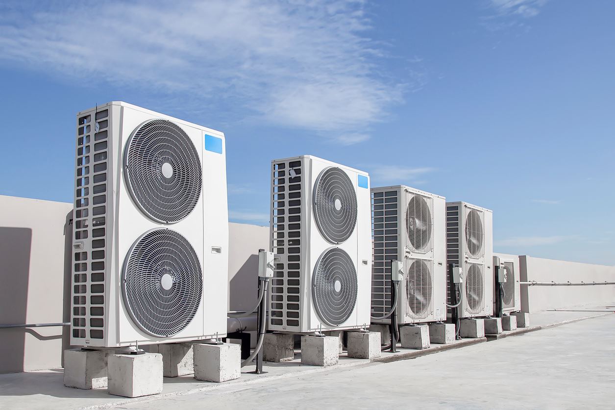 An air conditioning (HVAC) system on the roof of a building on a sunny day.