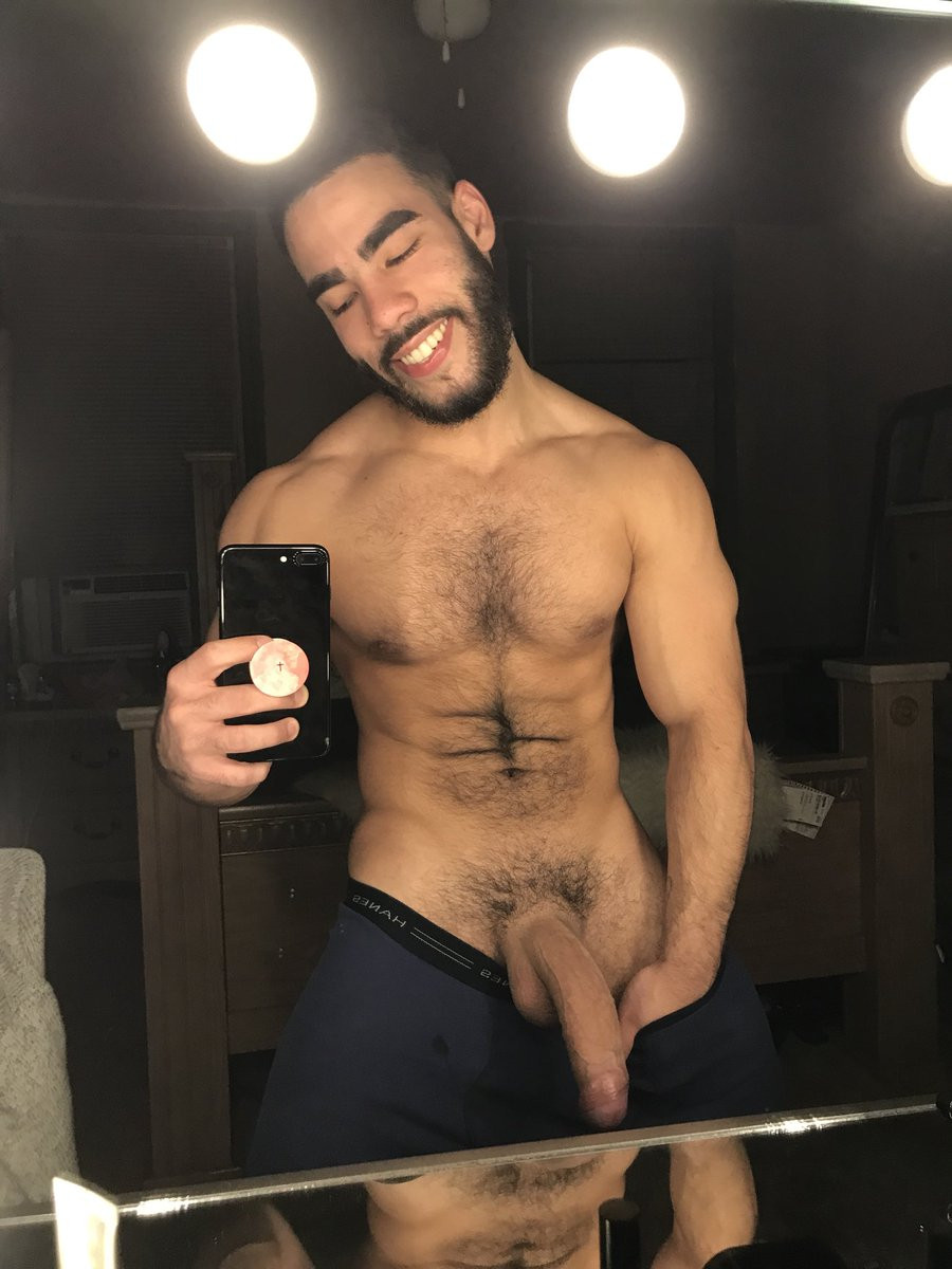 Papi Suave posing in front of the mirror in iphone mirror selfie shirtless showing off his massive flaccid uncut dick for gay xxx onlyfans subscribers