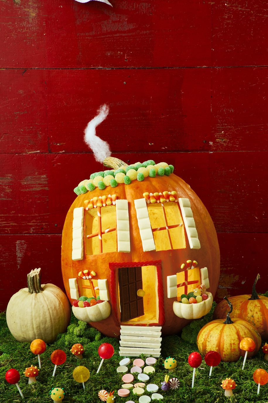 pumpkin carving ideas, pumpkin designed with candy and carved to look like a house