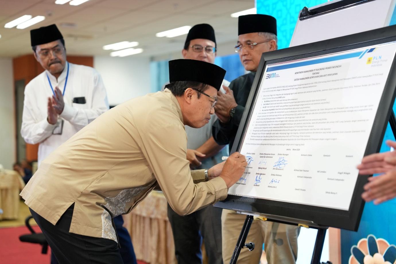 A group of men looking at a presentation Description automatically generated