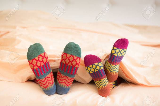 Couple Sleeping with Socks and Duvet