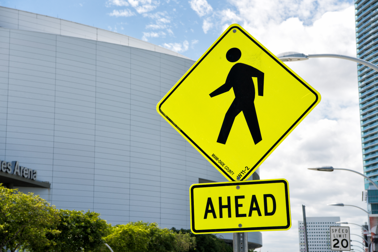 pedestrian crossing sign on a busy road