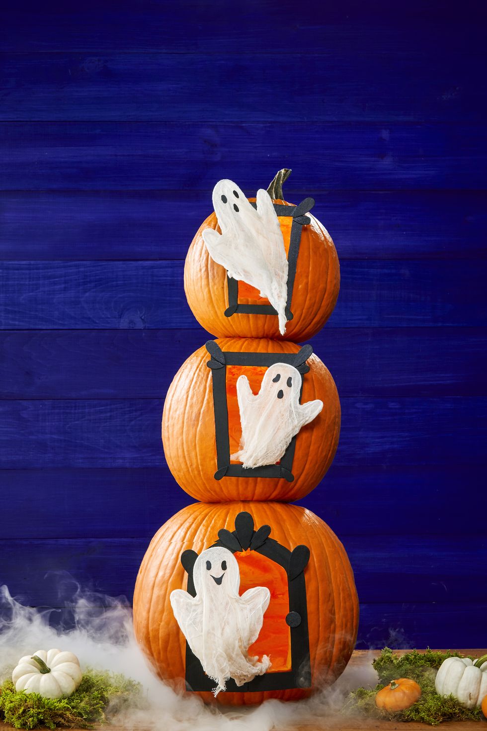 pumpkin carving ideas, three pumpkins stacked on top of each other with ghost designed