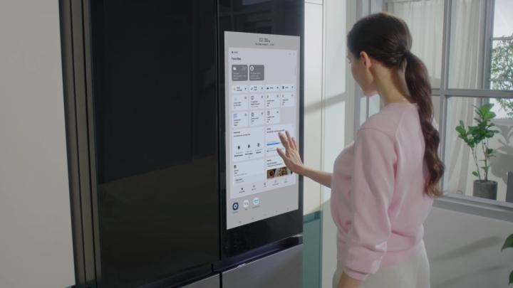 Mulher em pé na frente da geladeira com a porta aberta

Descrição gerada automaticamente com confiança média