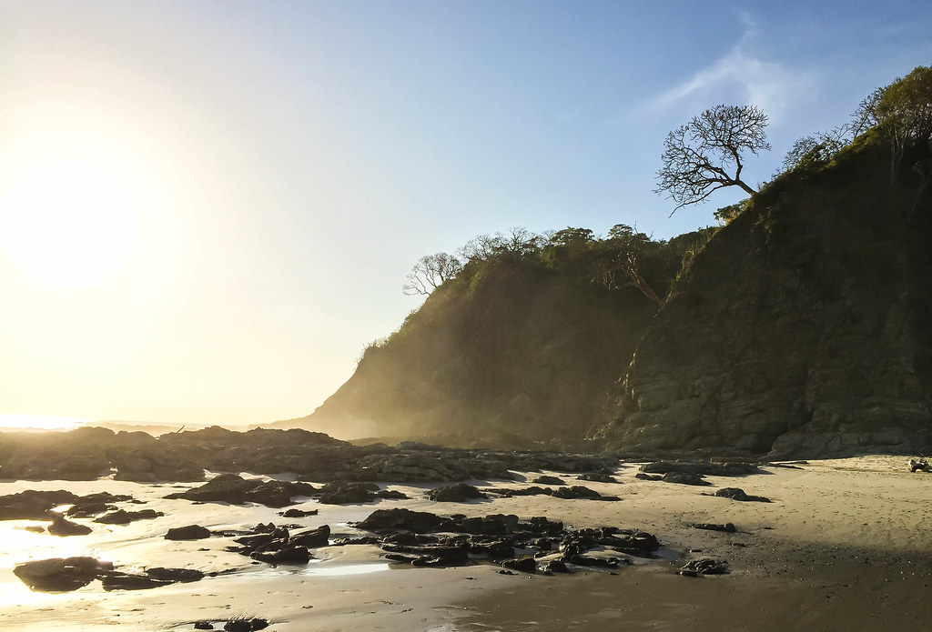 beautiful sunset on black sand beach in Costa Rica.