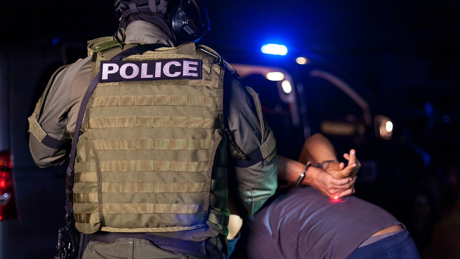 (policeman arresting a person)