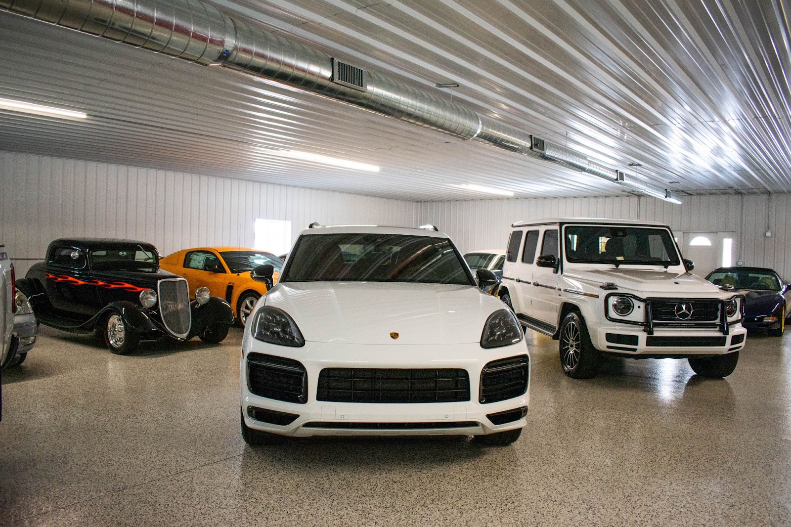 nice cars inside a steel pole barn