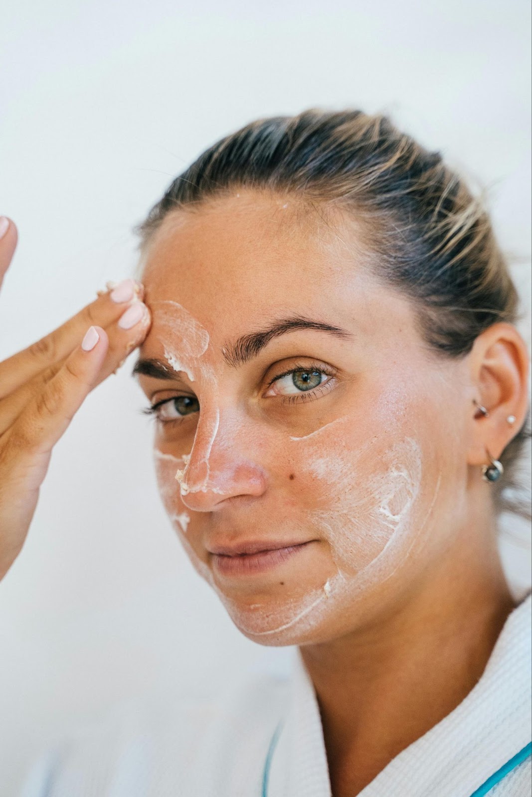 Beautiful blonde woman applying ultra creamy whipped moisturiser, a natural diy face skin care