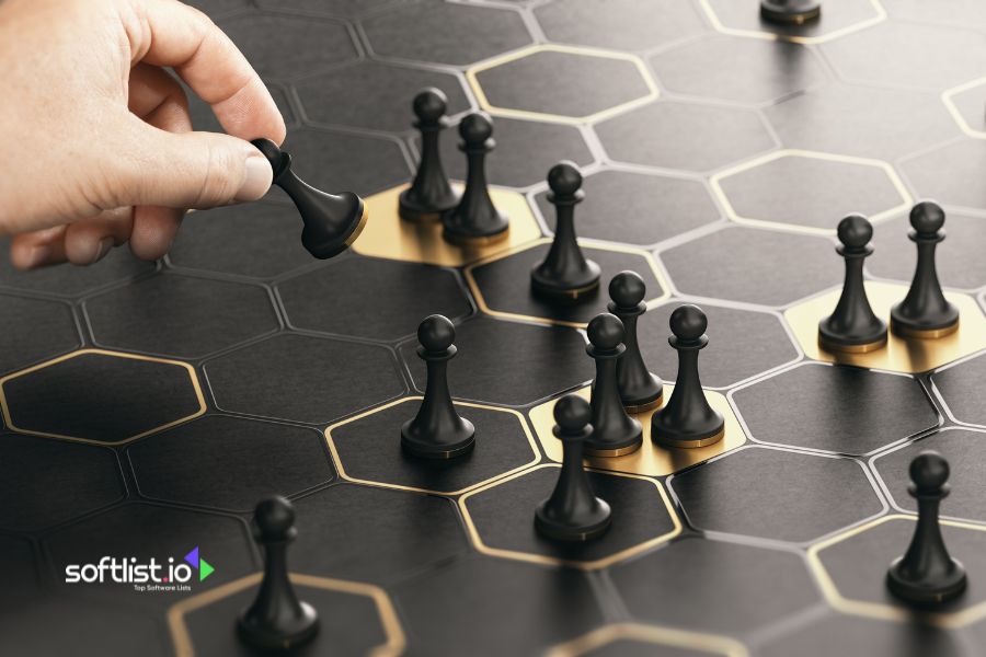 Hand placing chess piece on a board with black and gold hexagons.