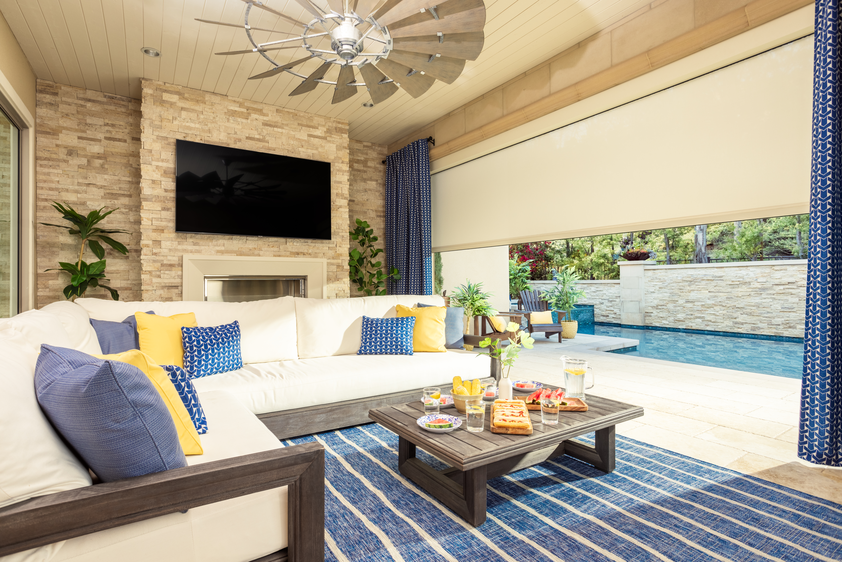 Back porch area with roller shades blending with brick walls