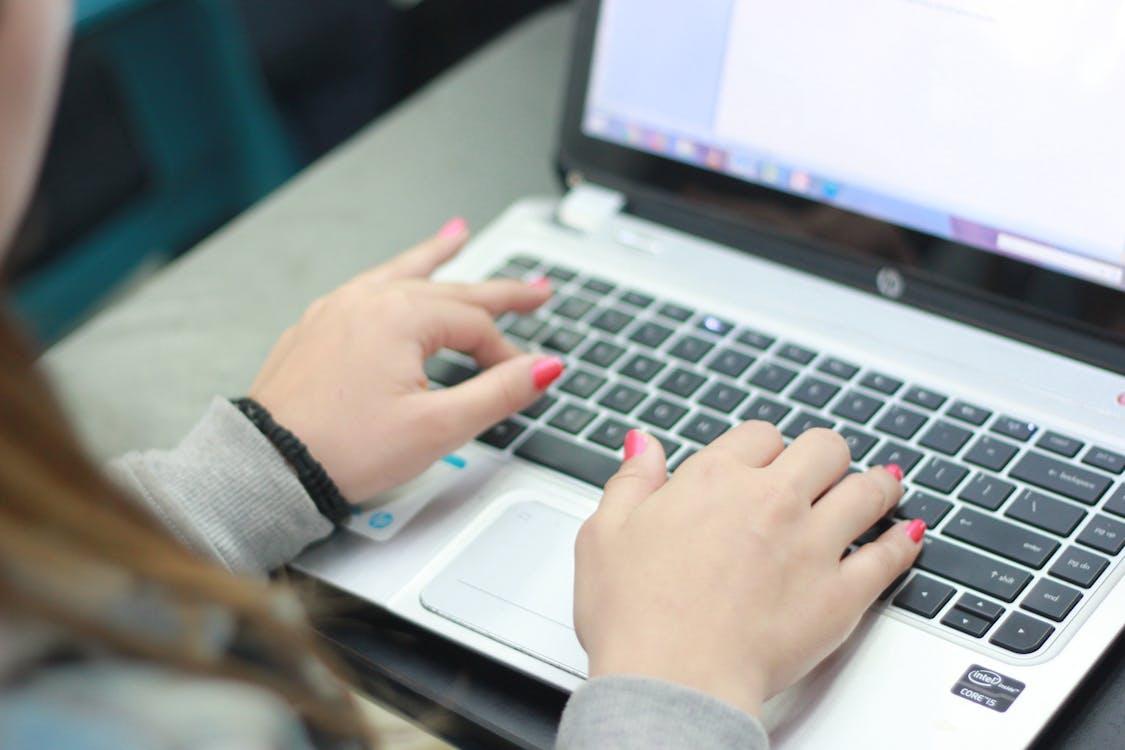 Free Close Up Photo of a Person Using Laptop Stock Photo