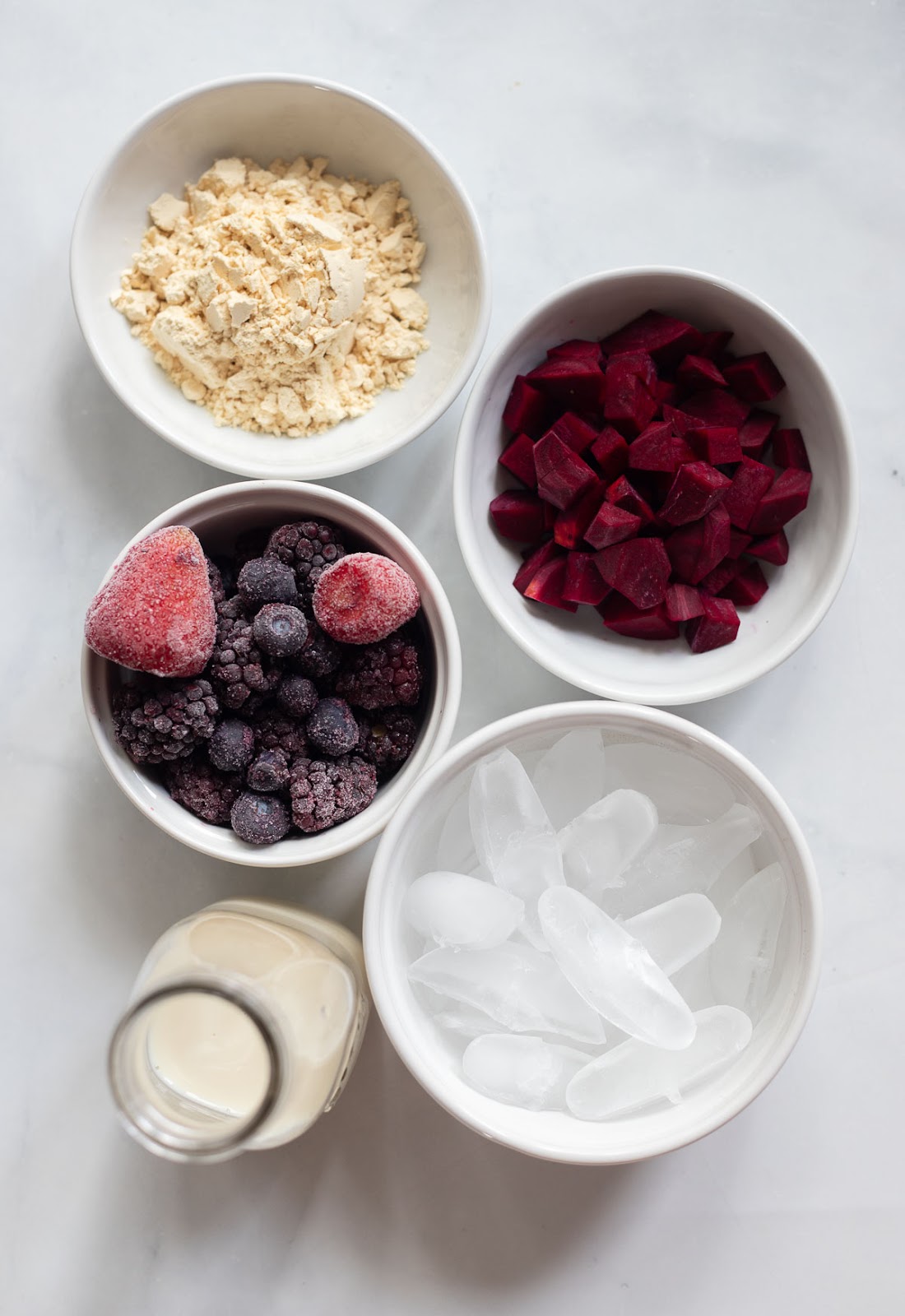 raw ingredients for berry protein smoothie bowl