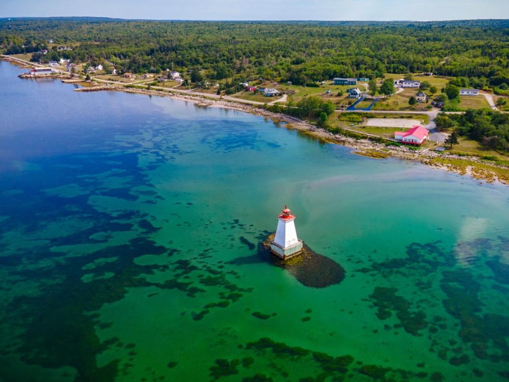 Aerial view of a coast and a lighthouse.