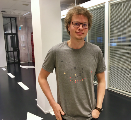 Erik wearing a grey T-shirt with a data visualization printed on it.