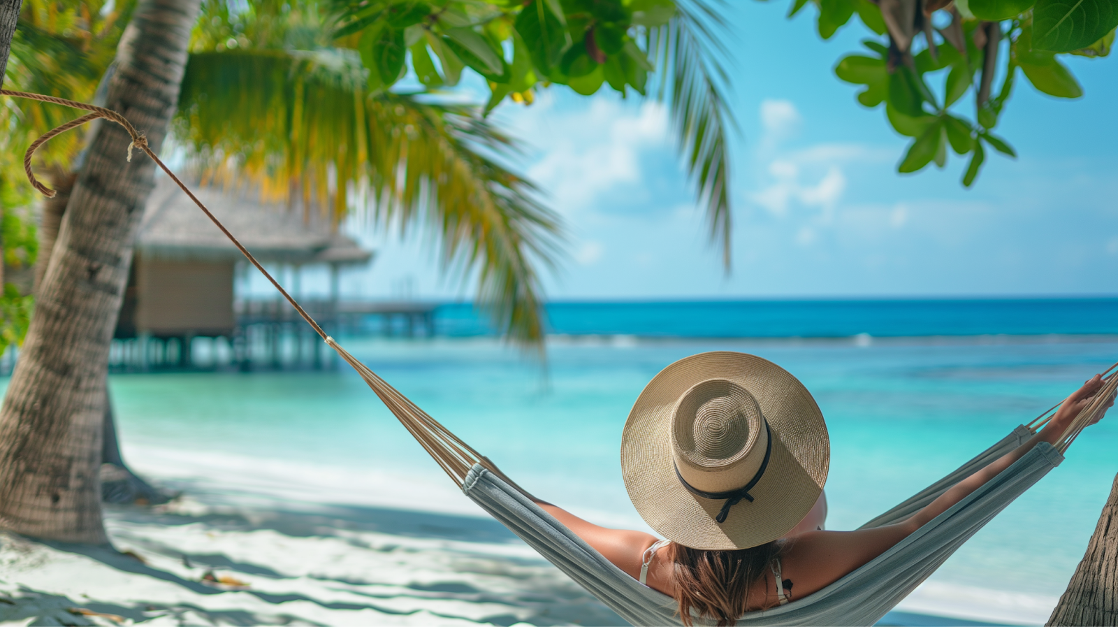 A closeup of a female visitor relaxing in a hammock in the Maldives enjoying the peaceful off-season atmosphere