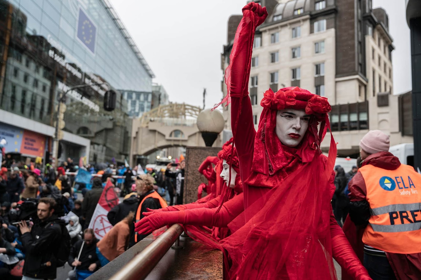 A Red Rebel raises his fist as rebels march past the EU parliament.