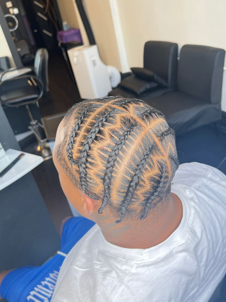 Back view of a guy showing off his pop smoke braids