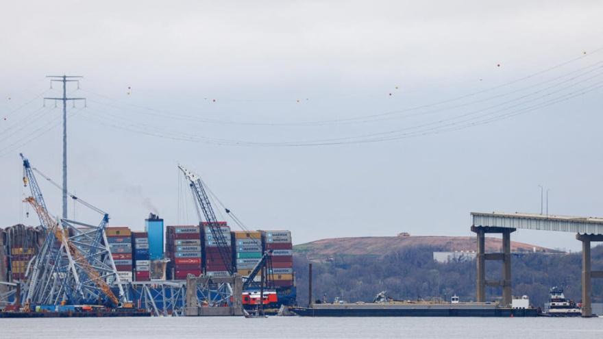 Tugboat Crystal Coast pushes a fuel barge under a remaining section of the collapsed Francis Scott Key bridge as salvage work continues, in Baltimore, Maryland, U.S., April 1, 2024. The barge, used to