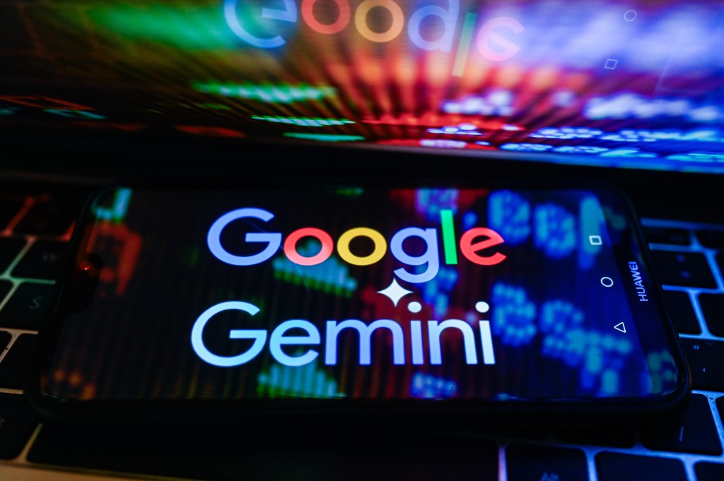 In this photo illustration, a Google Gemini logo is displayed on a smartphone with stock market percentages in the background.