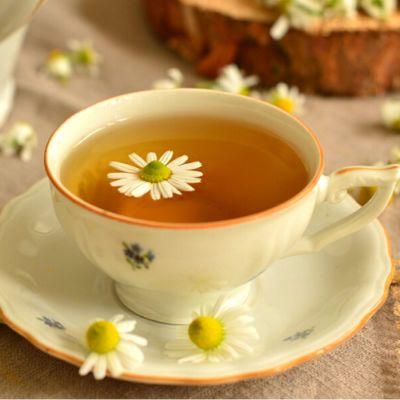 A cup of tea with a flower floating in it

Description automatically generated
