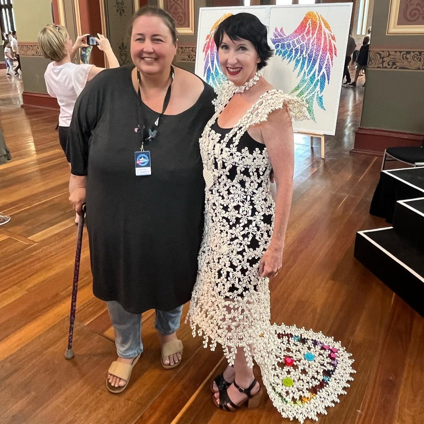 A photo of Veronica Young standing with Fleur Watkins, who competed on LEGO Masters Australia.  Fleur is wearing the LEGO wedding dress made by Veronica.