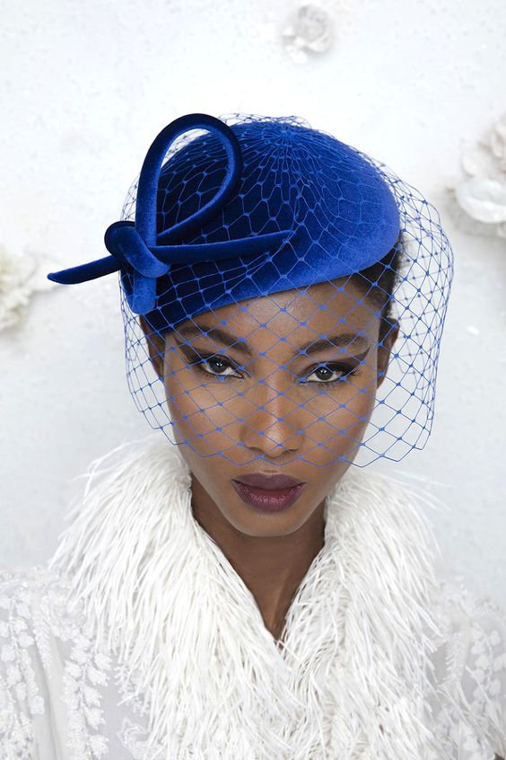 Picture of  a lady rocking a gorgeous blue fascinator  hat 
