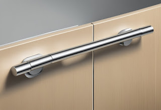 Sleek, modern cupboard door handles in contemporary setting. Clean lines, brushed metal finish, minimalist design