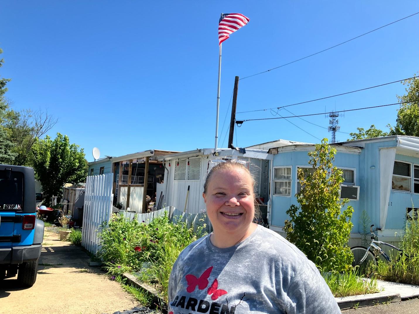 A person standing in front of a house

Description automatically generated