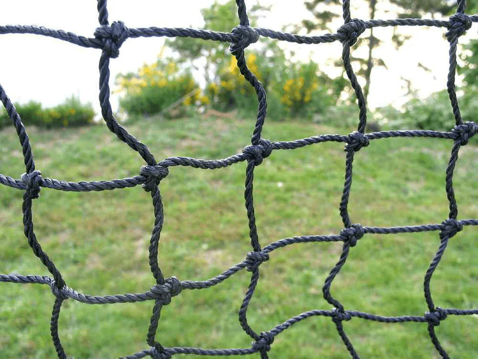 An image zooming in on the netting wall of a batting cage.