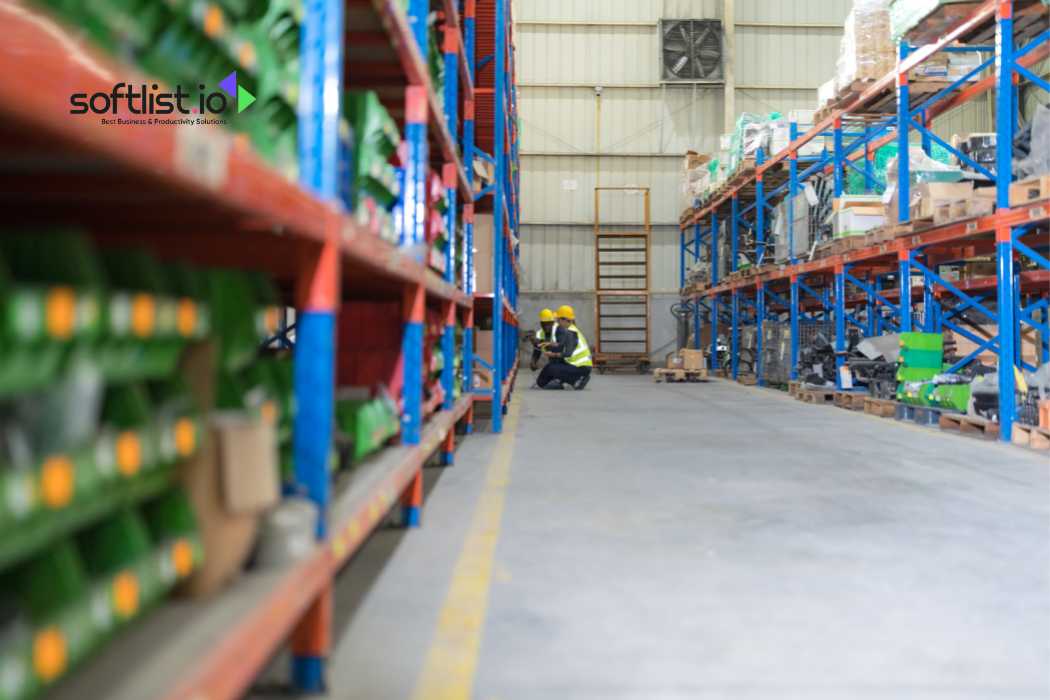 Worker in a high-visibility vest moving a pallet in a warehouse