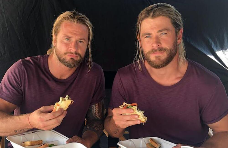  Two buff long-haired blonde men with blue eyes are eating sandwiches together while discussing the geo-political implications of global warming. Or they’re talking about trucks. Not sure.