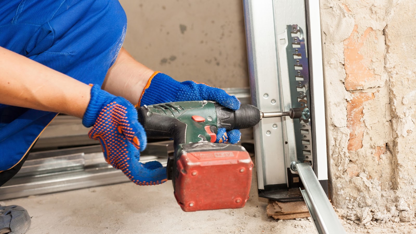 A professional technician installing garage door tracks
