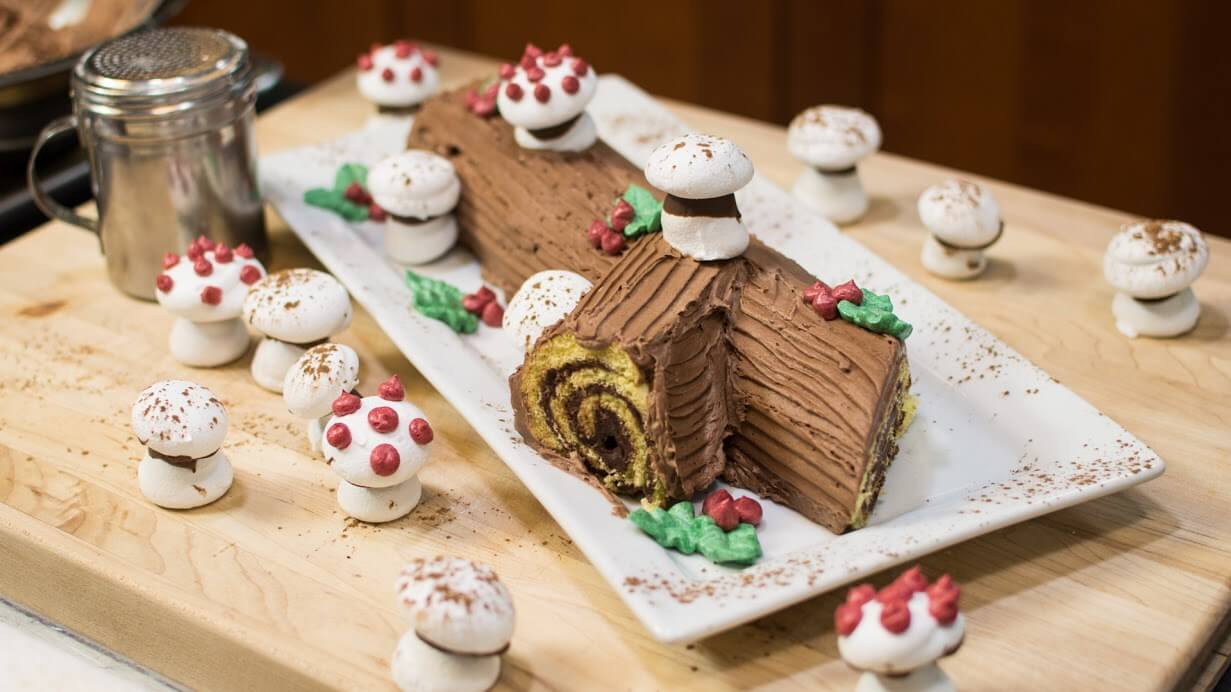The art of crafting a Bûche de Noël elaborately decorates it to resemble a wintry woodland log